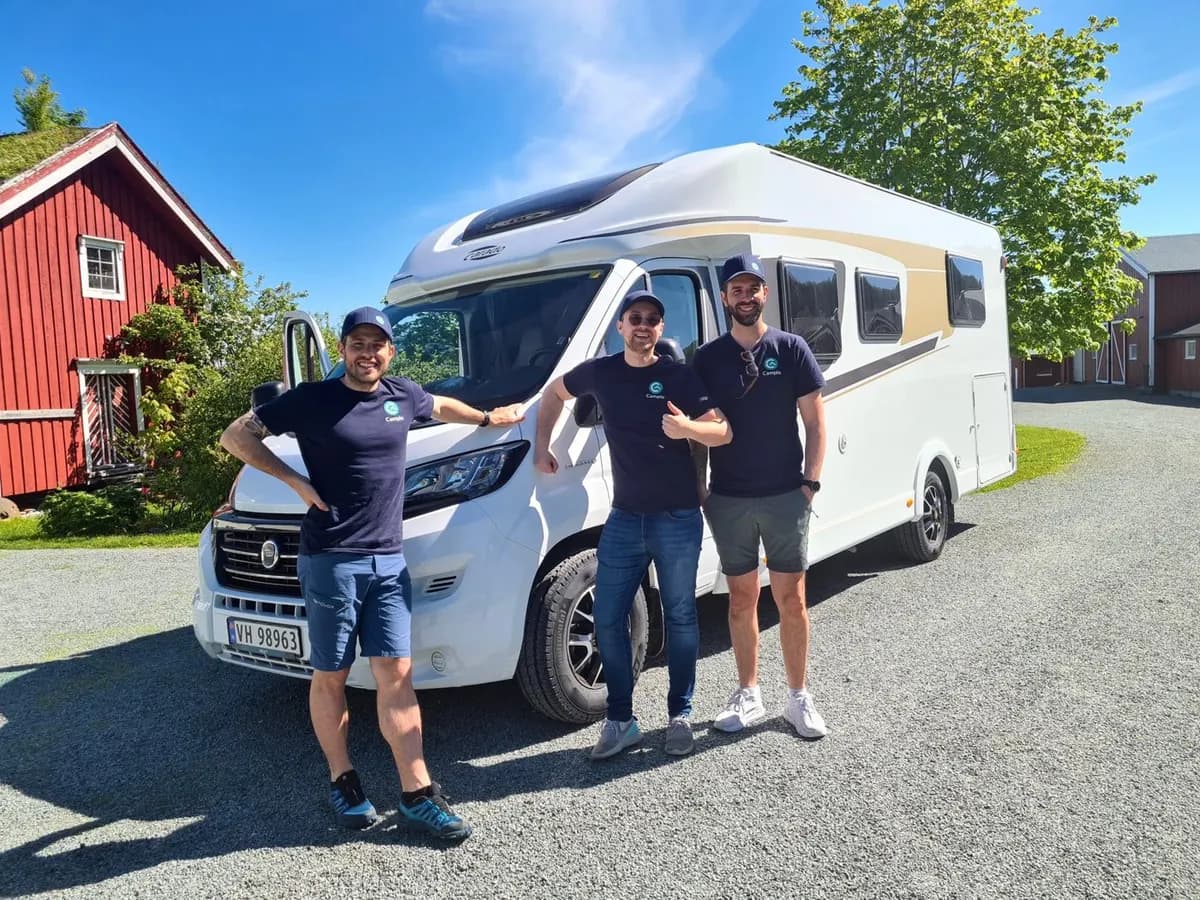 Three members of the Campio team in Campio shirts in front of a motorhome